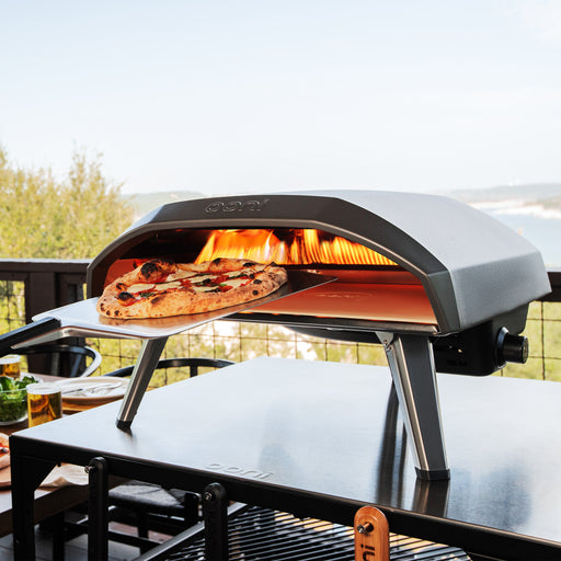 Koda 16 Pizza Oven with pizza peel on top of modular table